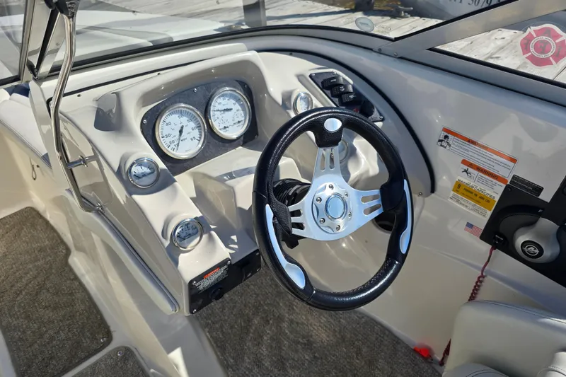 Slide: The Image of 2008 Larson Senza 186 boat dashboard with steering wheel and gauges. - 17