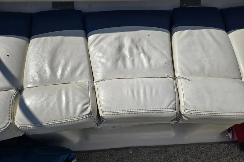 Slide: The Image of Worn white leather seats on a 2008 Larson Senza 186 boat. - 19