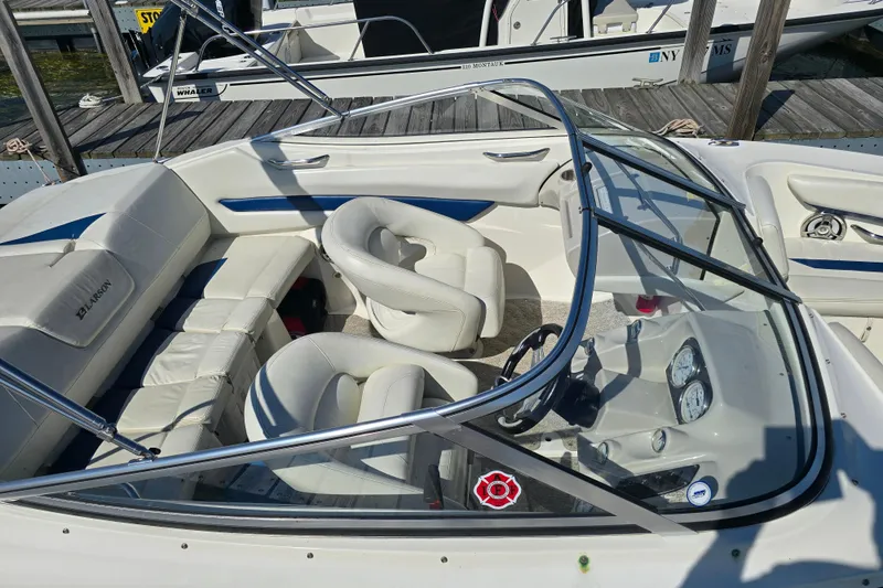 Slide: The Image of 2008 Larson Senza 186 boat interior with white seating and dashboard view. - 8