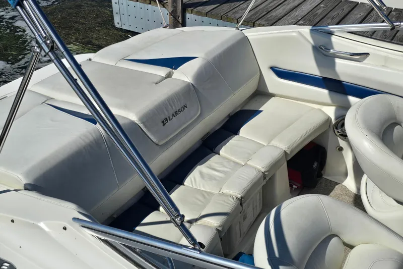 Slide: The Image of 2008 Larson Senza 186 boat interior with white seating and chrome details. - 9