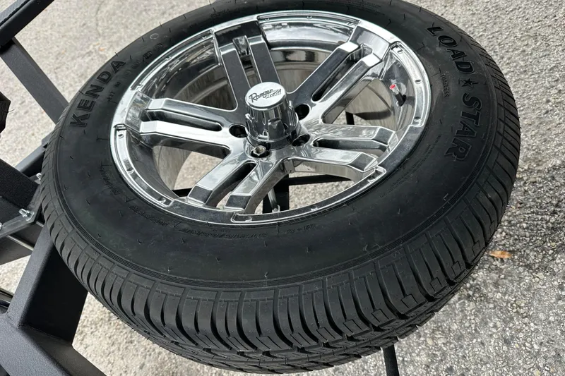 Slide: The Image of Chrome wheel with Kenda Load Star tire on Ranger ALPHA 208, 2026 model. - 31