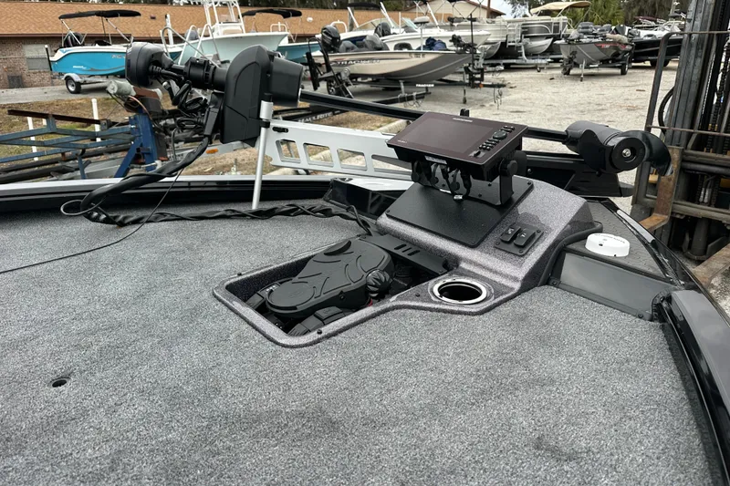 Slide: The Image of 2026 Ranger ALPHA 208 boat deck with advanced navigation equipment in a marina setting. - 8