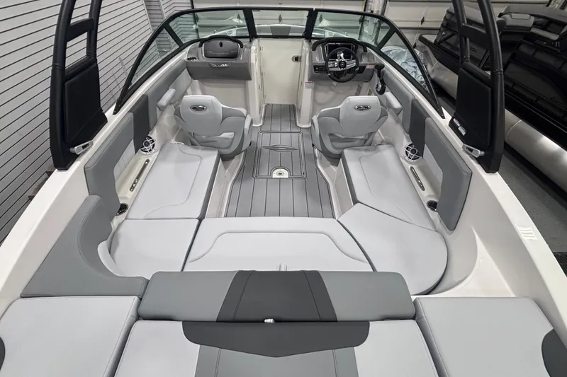 Slide: The Image of 2026 Chaparral 23 SSi boat interior with sleek gray seating and modern dashboard. - 13