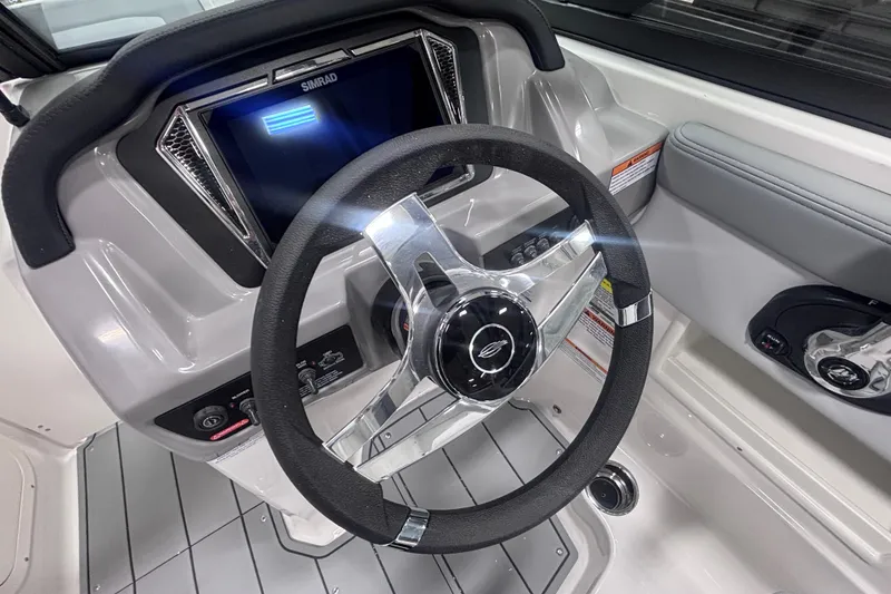 Slide: The Image of Steering wheel and dashboard of 2026 Chaparral 23 SSi boat with Simrad display. - 17