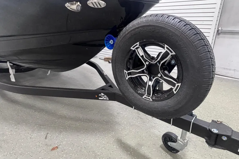 Slide: The Image of 2026 Chaparral 23 SSi boat on trailer with stylish black wheel. - 3