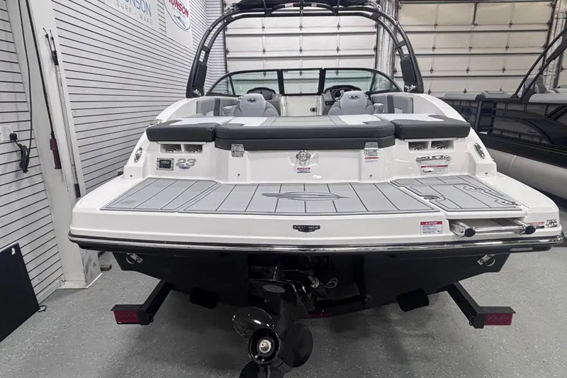 Slide: The Image of 2026 Chaparral 23 SSi boat in showroom, rear view with swim platform and seating. - 8