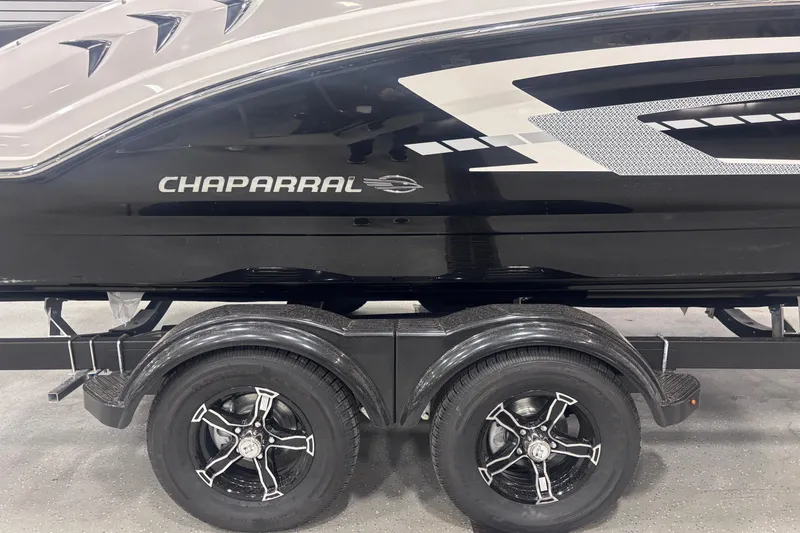 Slide: The Image of 2026 Chaparral 23 SSi boat on trailer, sleek black design with stylish graphics. - 10