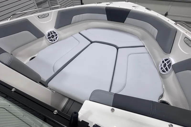 Slide: The Image of 2026 Chaparral 23 SSi boat interior with cushioned seating and built-in speakers. - 21
