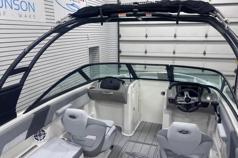 Slide: The Image of 2026 Chaparral 23 SSi boat interior with sleek design and modern steering console. - 28