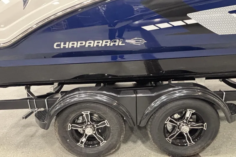 Slide: The Image of 2026 Chaparral 23 SSi boat on trailer, featuring sleek design and dual wheels. - 10