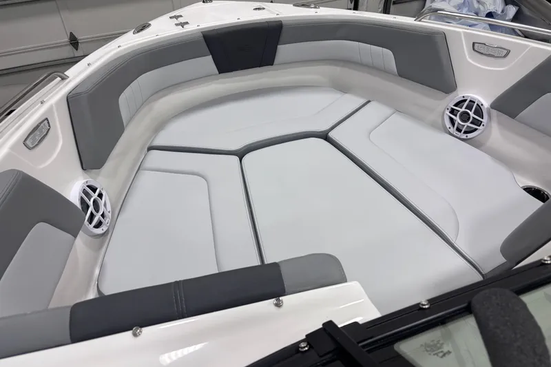 Slide: The Image of 2026 Chaparral 23 SSi boat interior with gray and white cushioned seating. - 15