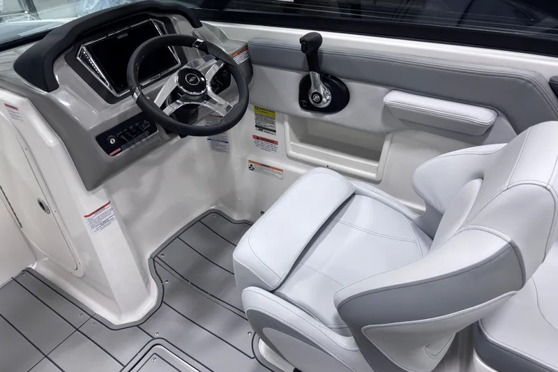Slide: The Image of 2026 Chaparral 23 SSi boat interior with modern steering and seating design. - 17