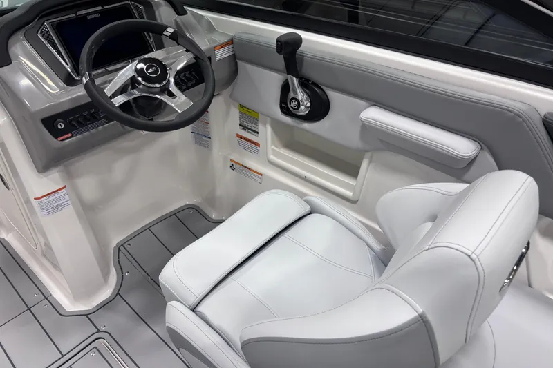 Slide: The Image of 2026 Chaparral 23 SSi boat cockpit with steering wheel and control panel. - 21