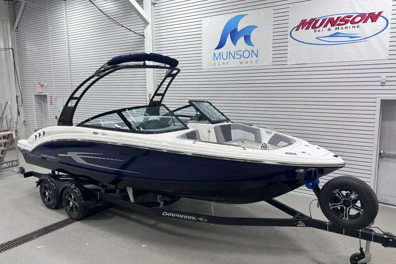 Slide: The Image of 2026 Chaparral 23 SSi boat in showroom, featuring sleek design and modern features. - 6