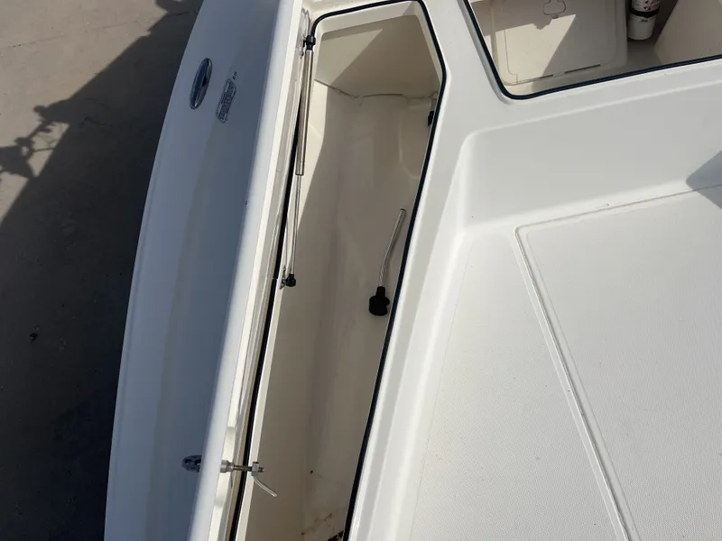 Slide: The Image of Open storage compartment of a 2014 Mako 21 LTS boat. - 14