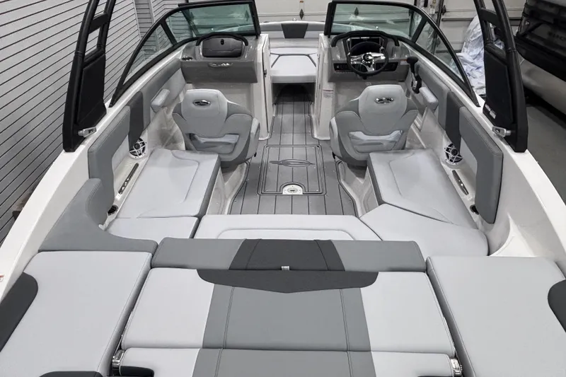 Slide: The Image of 2026 Chaparral 23 SSi boat interior with gray seating and modern dashboard design. - 22