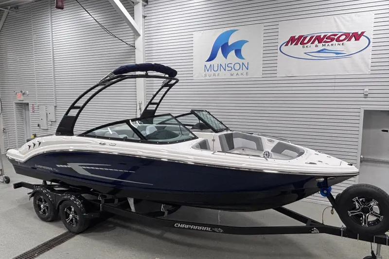 Slide: The Image of 2026 Chaparral 23 SSi boat in showroom, displayed on trailer, Munson Ski & Marine signage. - 5