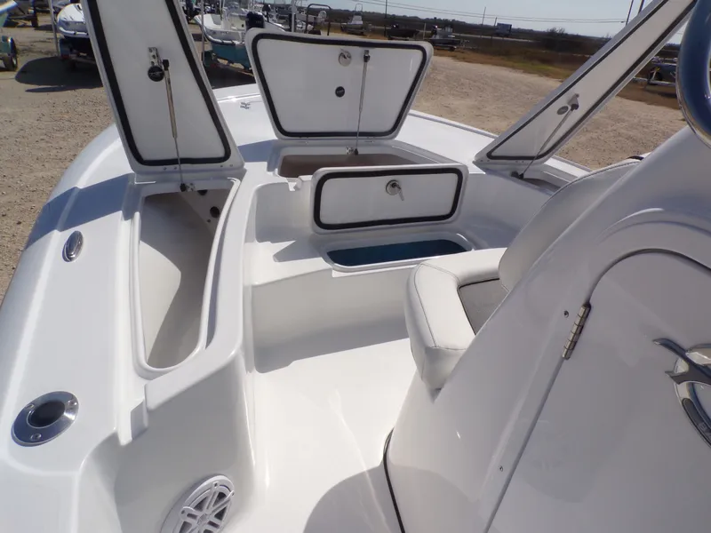Slide: The Image of Interior view of 2026 Tidewater 2110BMT boat with open storage compartments. - 15