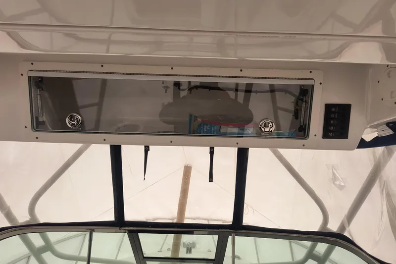 Slide: The Image of 2015 Robalo R305 Walkaround boat interior with overhead storage compartment. - 12