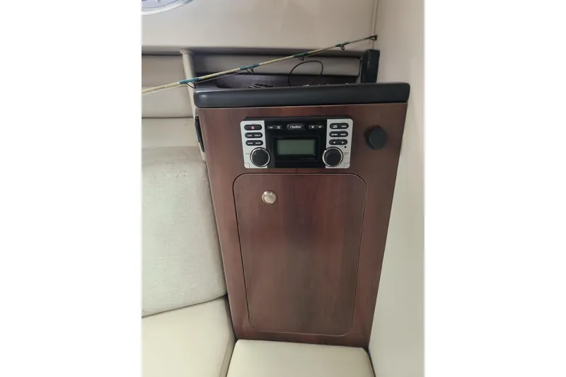 Slide: The Image of 2015 Robalo R305 Walkaround cabin with wood panel and stereo system. - 18