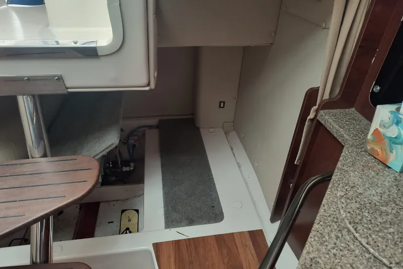 Slide: The Image of 2015 Robalo R305 Walkaround cabin interior with seating and wooden flooring. - 19