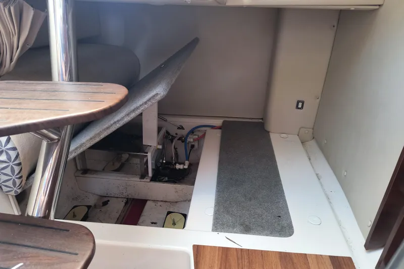 Slide: The Image of Interior view of a 2015 Robalo R305 Walkaround boat, showcasing cabin details and storage area. - 21