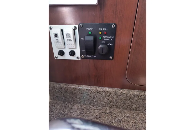 Slide: The Image of Control panel of 2015 Robalo R305 Walkaround boat with switches and indicators. - 22