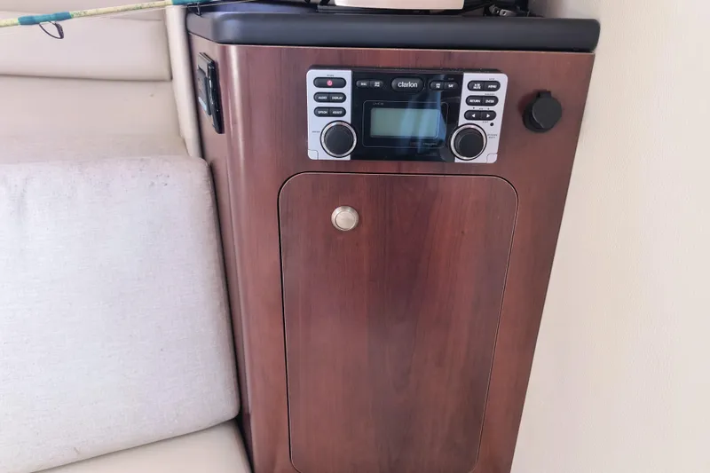 Slide: The Image of 2015 Robalo R305 Walkaround cabin with wood paneling and audio system. - 23