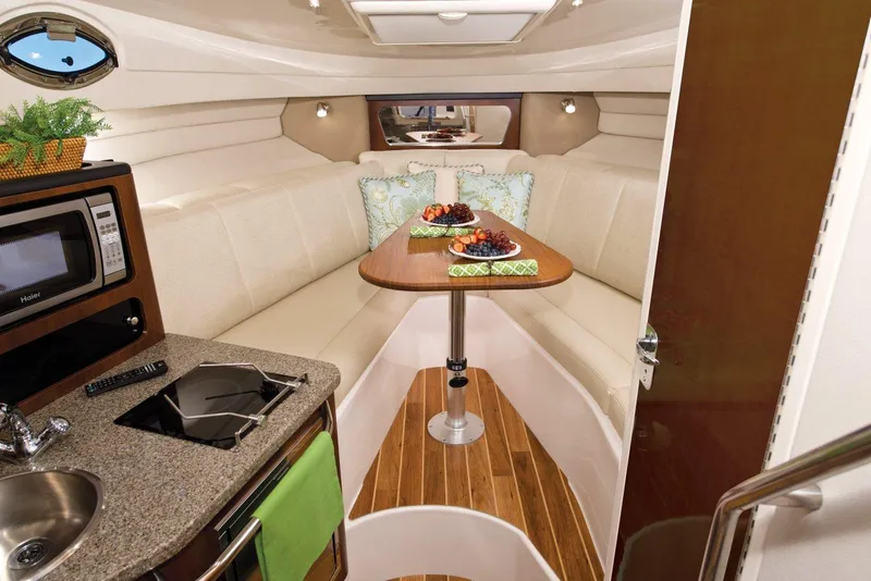 Slide: The Image of Manufacturer Provided Image: Interior of 2015 Robalo R305 Walkaround boat with dining area and kitchenette. - 8