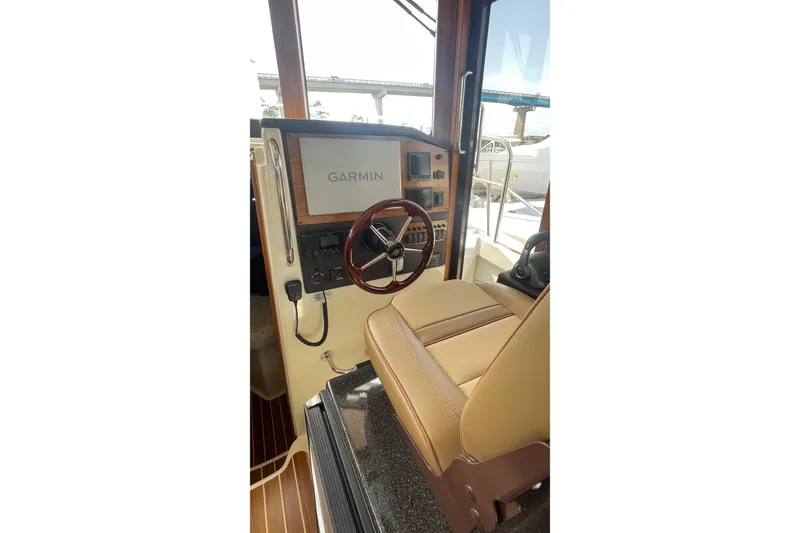 Slide: The Image of 2025 Ranger Tugs R-31 CB helm with Garmin navigation system and leather seating. - 5
