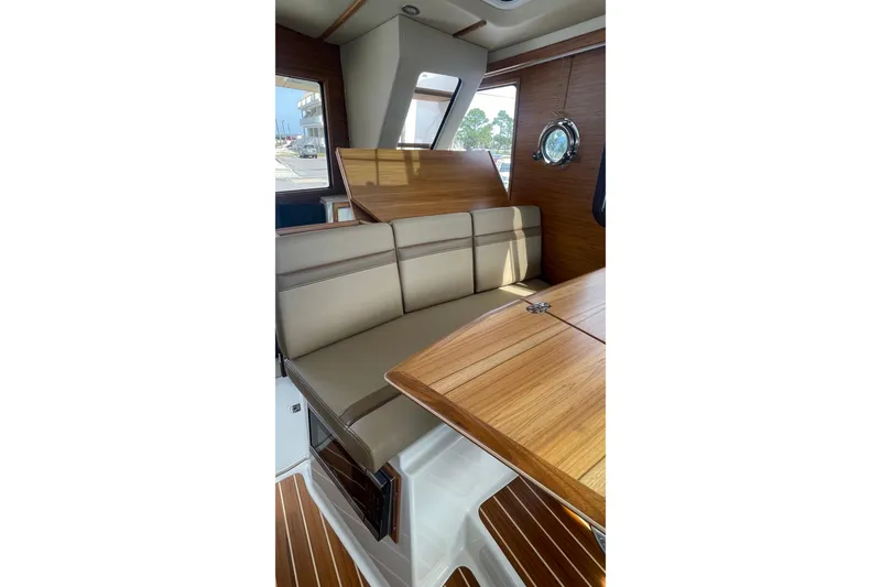 Slide: The Image of 2025 Ranger Tugs R-31 CB interior with wood and leather seating. - 6