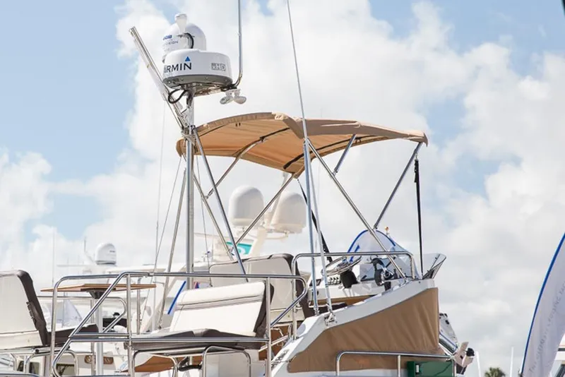 Slide: The Image of Manufacturer Provided Image: 2025 Ranger Tugs R-31 CB boat with radar and canopy against a cloudy sky. - 9