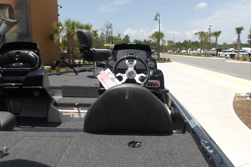 Slide: The Image of 2026 Nitro Z17 boat interior with steering wheel and seating, parked outdoors. - 11