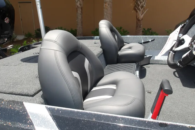Slide: The Image of 2026 Nitro Z17 boat interior with gray cushioned seats and steering wheel. - 17