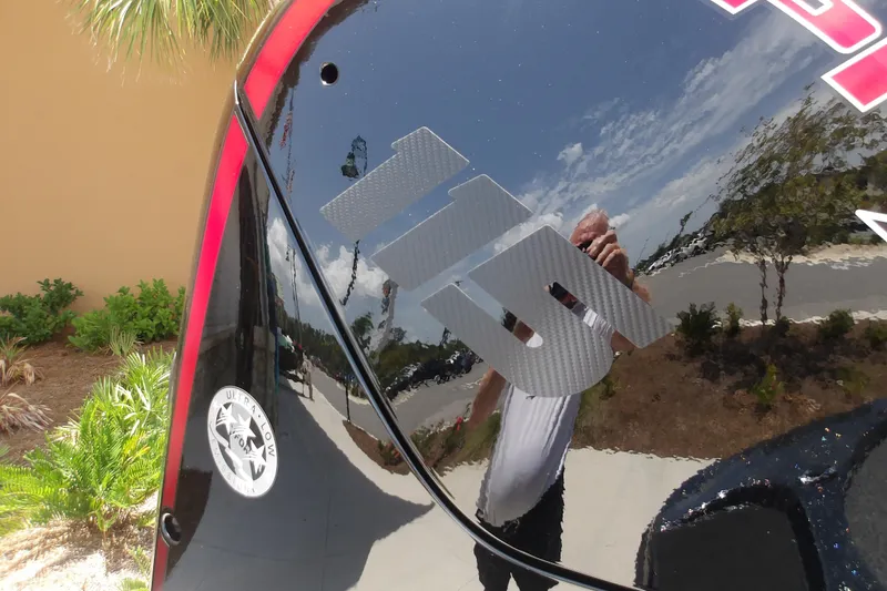 Slide: The Image of Reflective surface of a 2026 Nitro Z17 boat with logo and outdoor scenery. - 9
