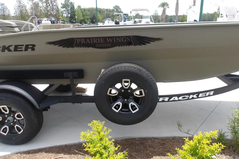 Slide: The Image of 2026 Tracker Grizzly 1650 T Prairie Wings Edition boat on trailer, side view. - 4
