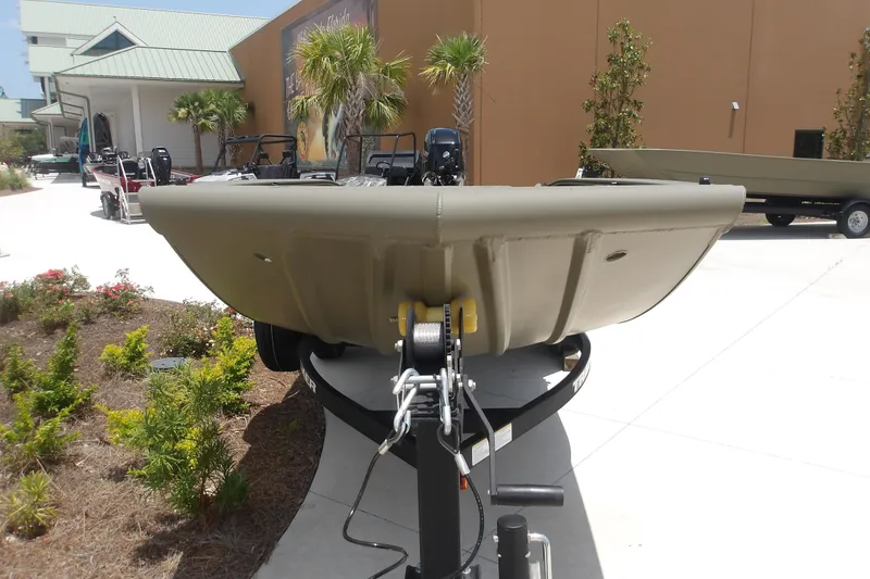 Slide: The Image of 2026 Tracker Grizzly 1650 T Prairie Wings Edition boat on trailer, outdoor display. - 2