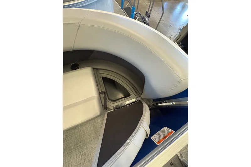 Slide: The Image of 2026 Sun Tracker Party Barge 16 DLX interior seating with storage compartment. - 77