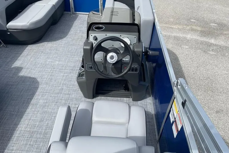 Slide: The Image of 2026 Sun Tracker Party Barge 16 DLX interior with steering console and seating. - 5
