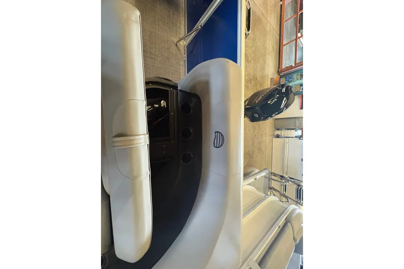 Slide: The Image of 2026 Sun Tracker Party Barge 16 DLX interior with seating and controls. - 79