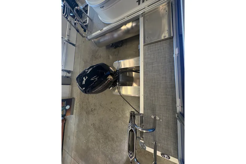 Slide: The Image of 2026 Sun Tracker Party Barge 16 DLX with Mercury outboard motor in showroom. - 80
