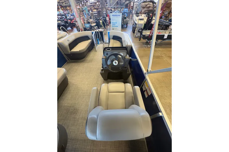 Slide: The Image of 2026 Sun Tracker Party Barge 16 DLX interior with steering console and seating. - 73
