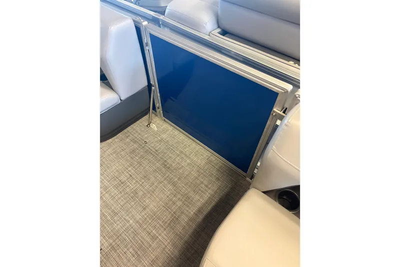 Slide: The Image of 2026 Sun Tracker Party Barge 16 DLX interior with blue panel and seating. - 81