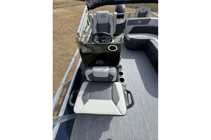 Slide: The Image of 2026 Sun Tracker Bass Buggy 18 DLX interior with seating and console, showcasing modern design. - 16