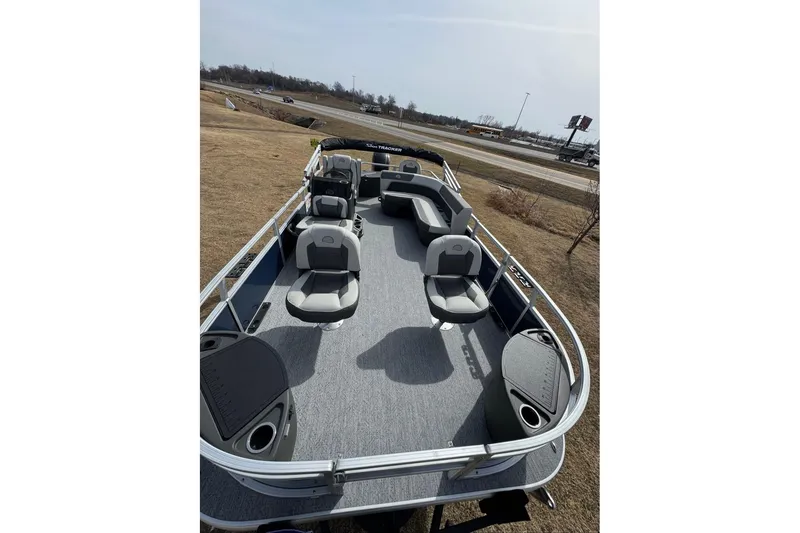 Slide: The Image of 2026 Sun Tracker Bass Buggy 18 DLX pontoon boat with spacious seating and modern design. - 2