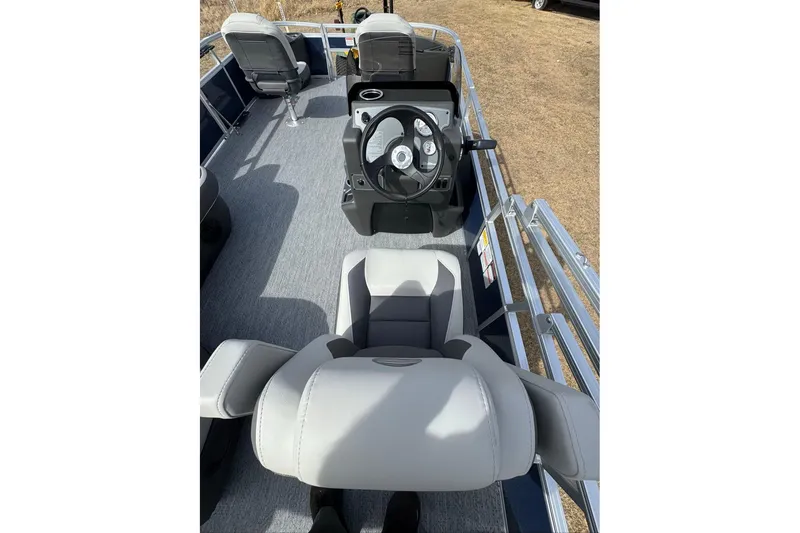 Slide: The Image of 2026 Sun Tracker Bass Buggy 18 DLX interior with steering console and seating. - 3