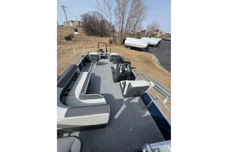 Slide: The Image of 2026 Sun Tracker Bass Buggy 18 DLX pontoon boat with spacious seating and steering console. - 7
