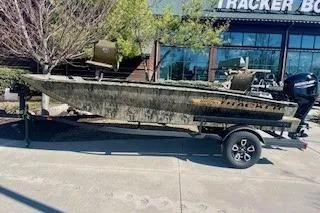 The Image of 2026 Tracker Grizzly 1756 T Marsh boat on trailer, parked outside dealership. - 0