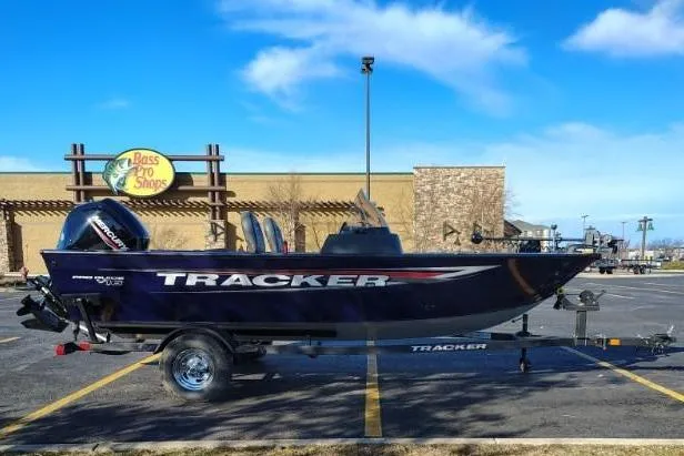 The Image of 2026 Tracker Pro Guide V-16 SC boat in front of Bass Pro Shops. - 0