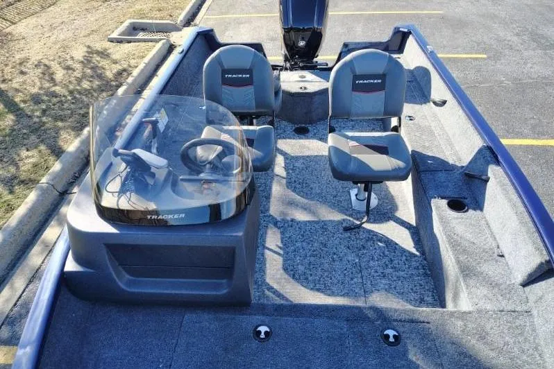 Slide: The Image of 2026 Tracker Pro Guide V-16 SC boat interior with dual seats and steering console. - 3